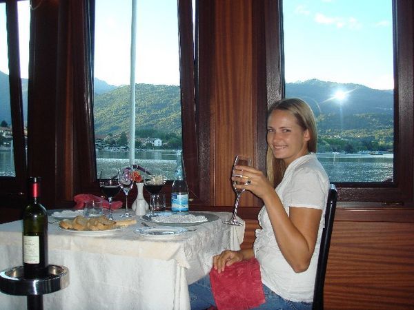 Kristi eating dinner on a boat on the lake
