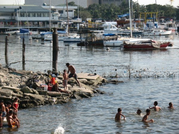 kids swimming in Manila Bay (water is not very clean)