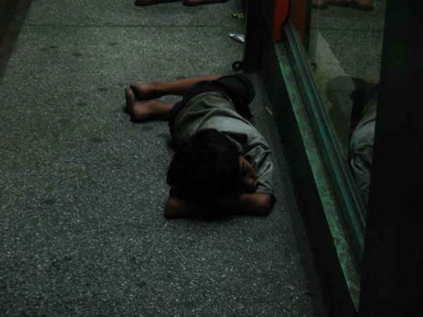 kid sleeping on the street at night in Manila
