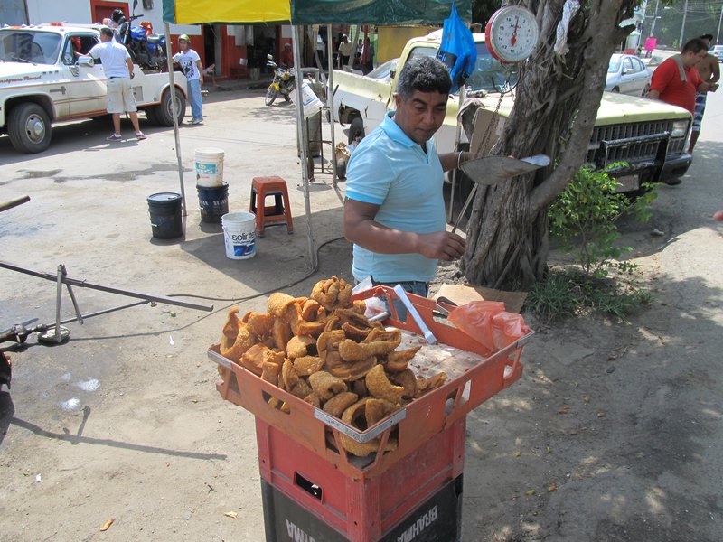 man selling chicharón in Ocumare de la Costa