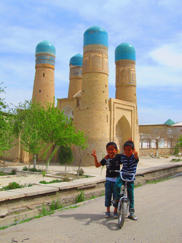 Uzbek boys posing in front of Char Minar gatehouse, Bukhara