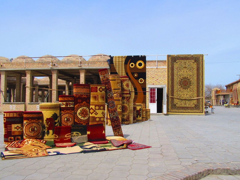 A market where they sell a whole lot of carpets in Bukhara