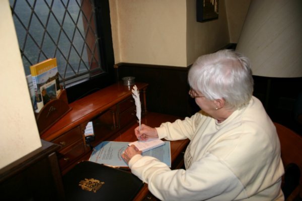 Mom at the desk writing a letter on Castle stationery
