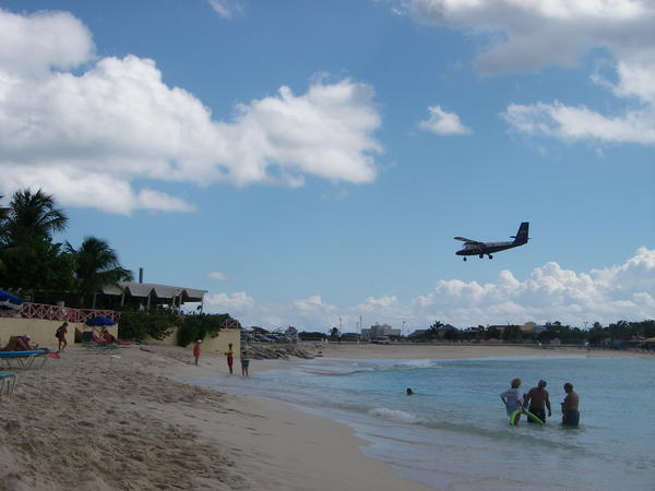 Plane landing over beach