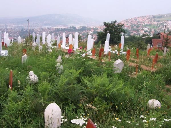 Cemetery with stone and wood grave markers