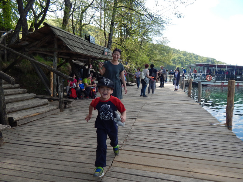 Riley running for the ferry at the Plitvice Lakes waterfalls