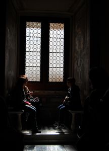 Tourists take a rest in the shows in the Vatican Museum