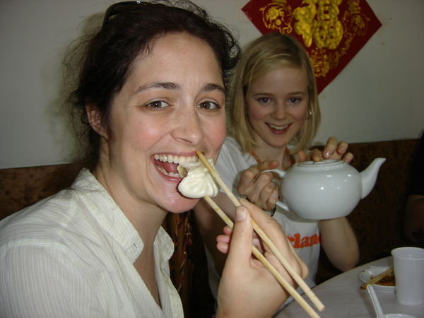 Beth eats a dumpling.