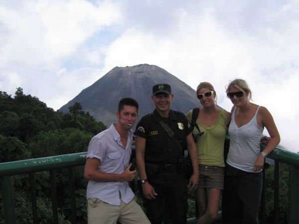 Armed policeman and gang - ready to climb the volcano in the background 