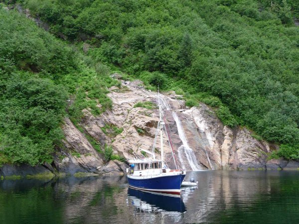 Yacht beside waterfall