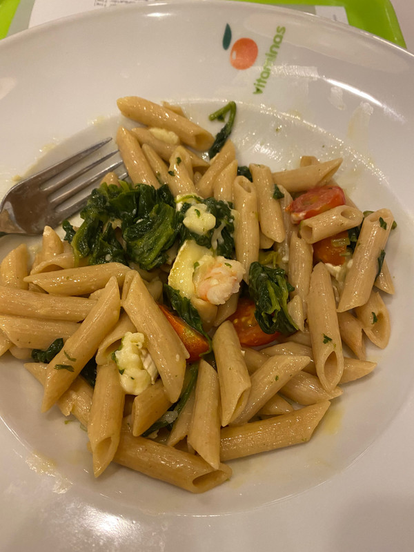 Warm pasta salad with Brie, shrimp, spinach and tomatoes.