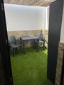 Our tiny backyard with plastic grass covering the marble floor.