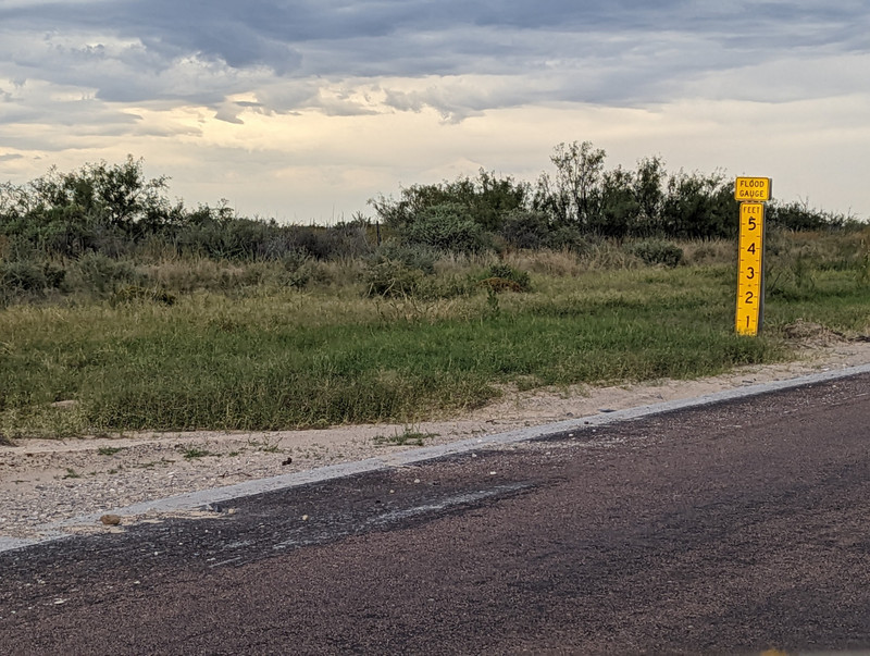 During our drives in the past several states, we have been told to not cross the road in places if there's water on the road - the water can be moving fast enough to sweep your car off the road, and could presage a flash flood across the road. 