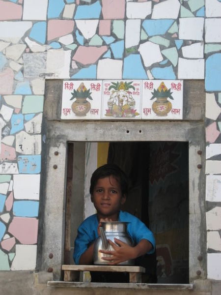 Boy selling water at kiosk