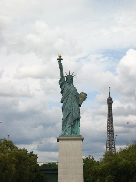 Mini Statue of Liberty in front of the Eiffel Tower Photo