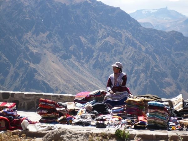 A peruvian woman having a moment with the mountains 