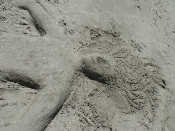 Buried in the sand sculpture