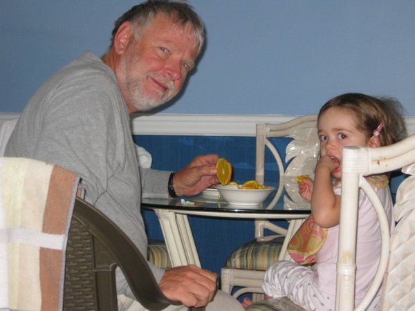Ella enjoys sharing an orange with Papa whether at home or in the Bahamas