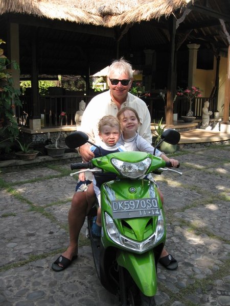 Papa giving kids a ride on the scooter