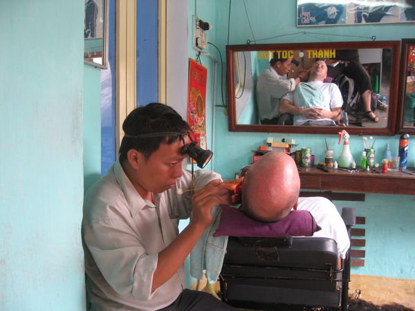 A hair cut involves an ear clean in Hoi An