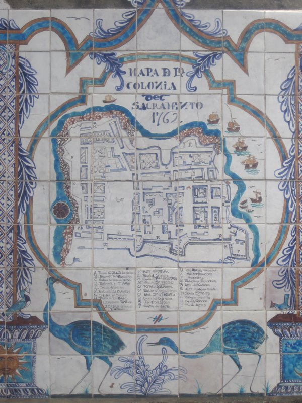 Old tiled map on a wall near sea front
