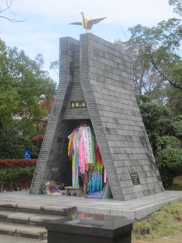 Shrine next to the statue where people can put there paper cranes