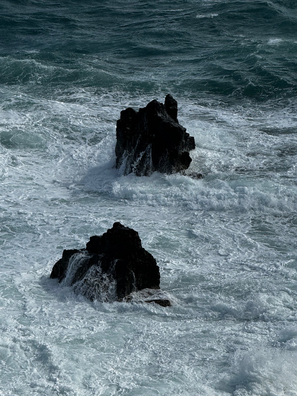 Waves crashing on volcanic rock