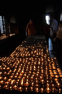 Monks lighting candles