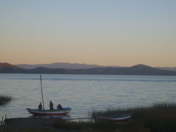 fishing boat coming in before sundown