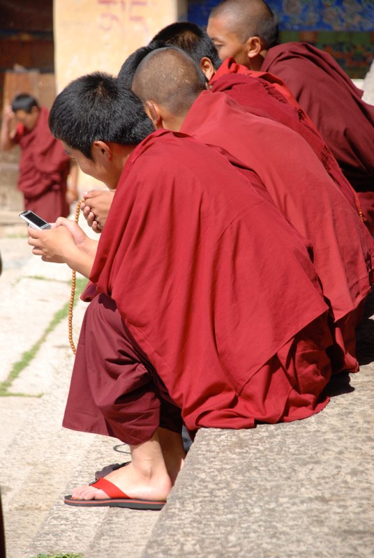 Some monks have beads, some have mobiles!
