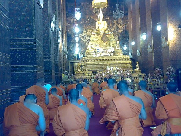 Monks chanting within another temple
