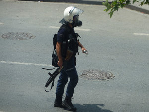 Policeman with tear gas cartridges at the ready