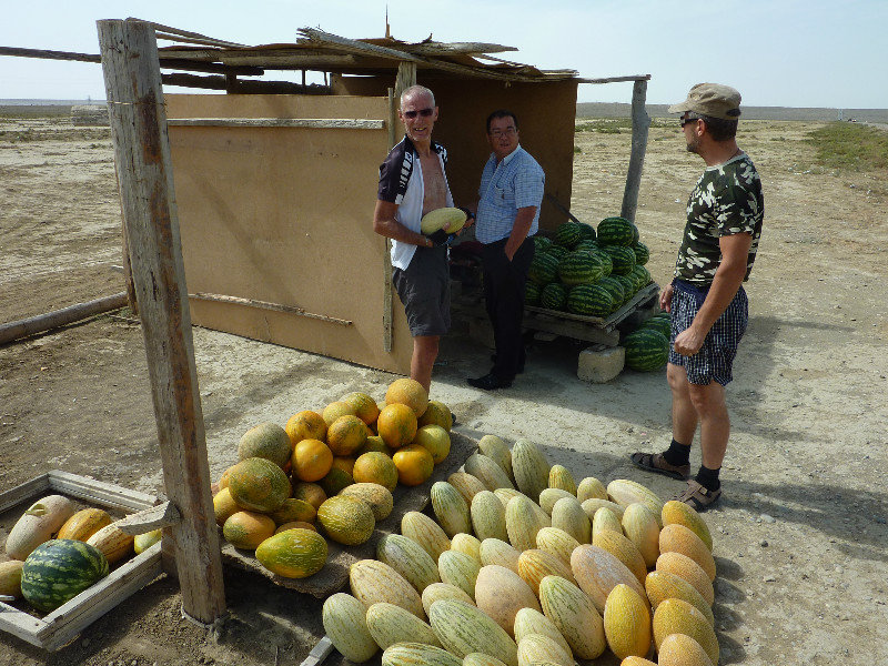 Derek buying a melon in the desert
