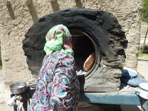 Grandmother baking bread in the traditional way