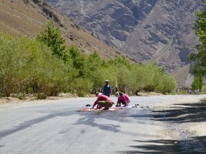 Tajiki ladies scrubbing their carpets