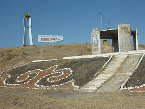 Old Soviet sign adorns the entrance to a new village