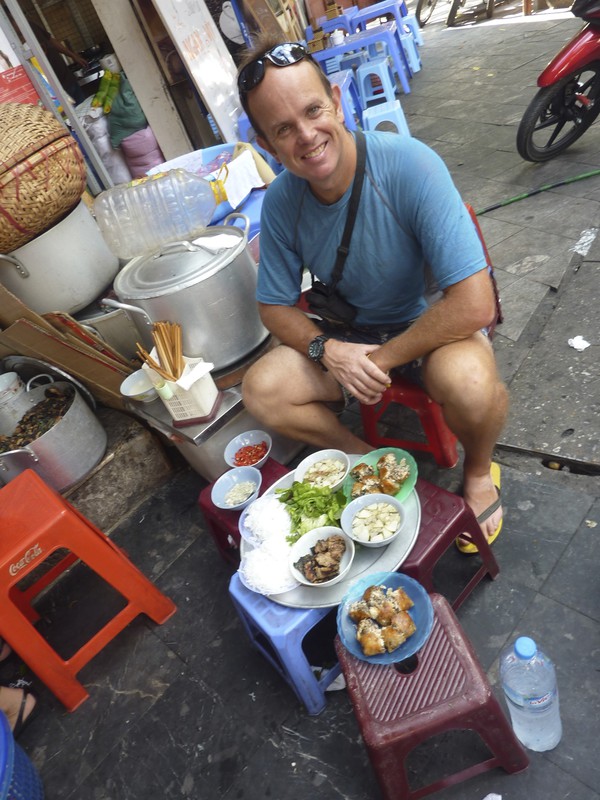 Enjoying Vietnamese food sat on Kindergarden chairs