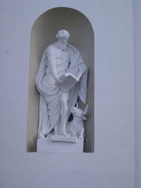 Man reading to a cow at the cathedral