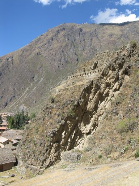 Inca warehouses for storing grain sit high about the town 