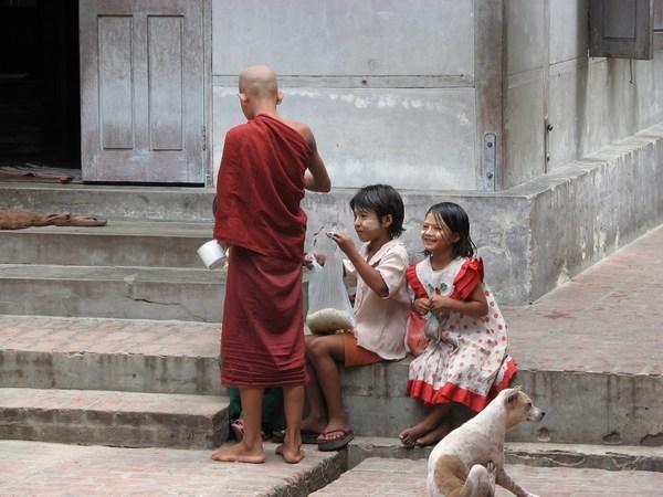 Local children receiving rice at the monastery