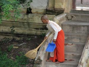 A nun sweaping up at Maha Aungmye Bonzan, Inwa