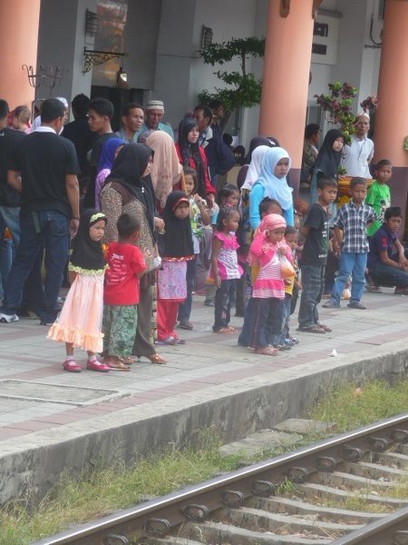 Locals await the arrival of the next train.