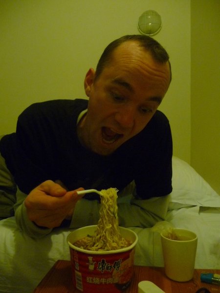 Kev eating Cup O' Noodle in the hotel room.
