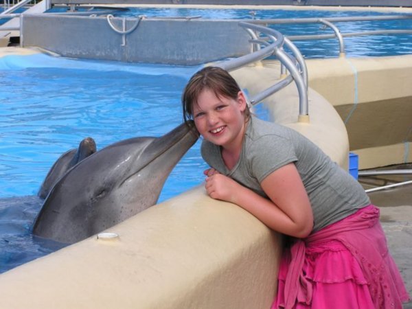 Ellie being kissed by a Dolphin
