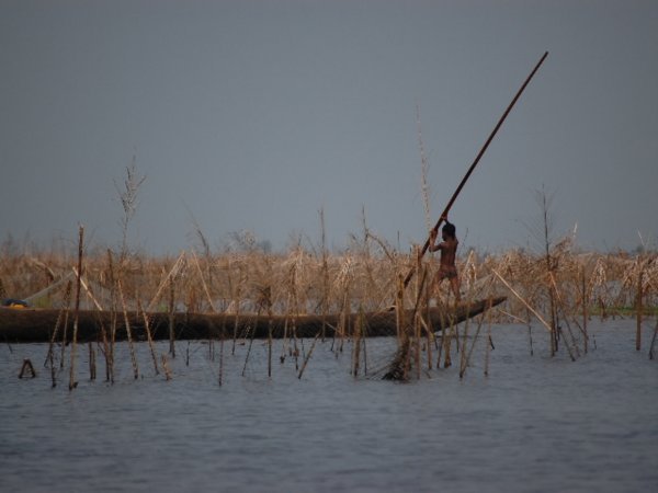 Child moving a pirogue solo