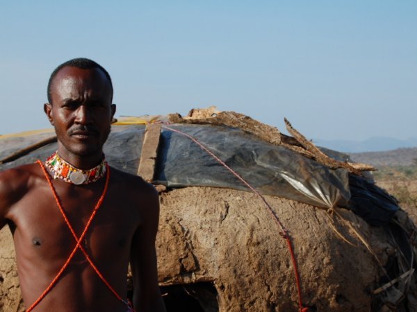 Samburu man and hut