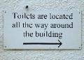 Despite this notice, the toilets are NOT all the way around the building. They are at the FAR END of the building.