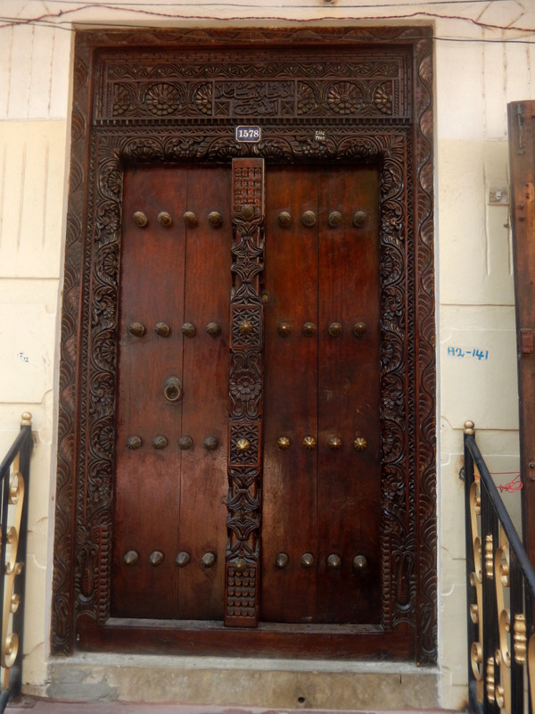 Typical elaborately carved, heavy door with brass studs