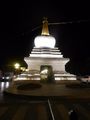 Night shot of a stupa in front of Potala