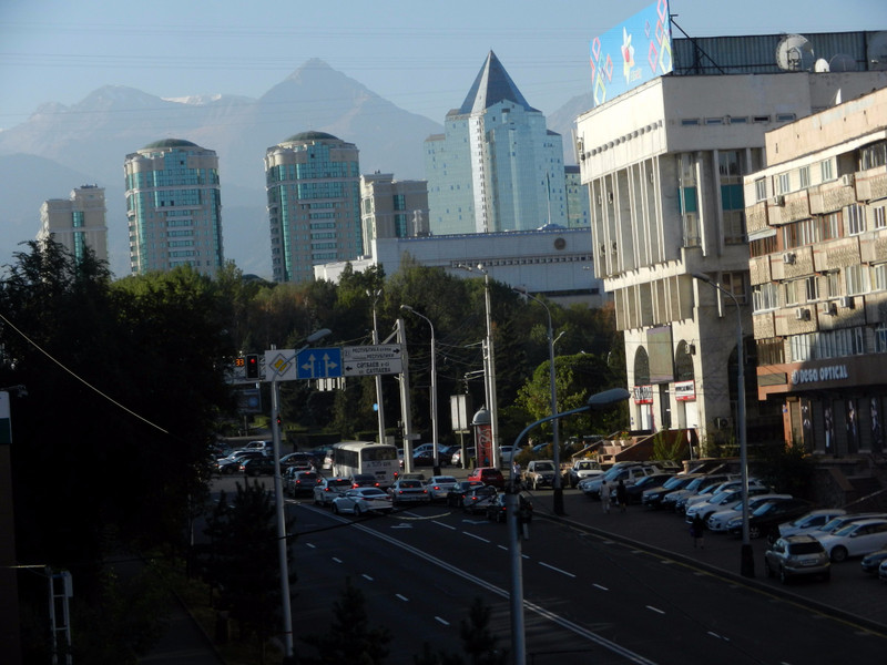 Almaty street scene with mountain backdrop
